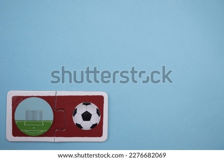 Soccer ball and goal picture puzzles, soccer ball and goal picture puzzles taken from above, placed on the left of a blue background.