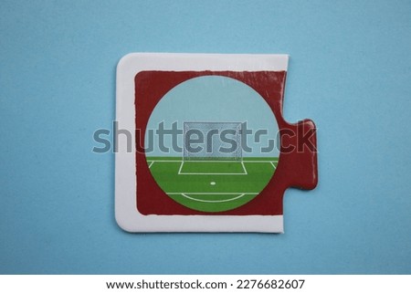 Football goal picture puzzle, football goal picture puzzle shot from above, placed on blue background.