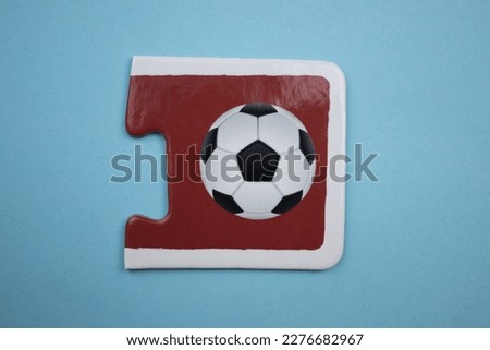 Soccer ball picture jigsaw, soccer ball picture jigsaw taken from above, placed on a blue background.