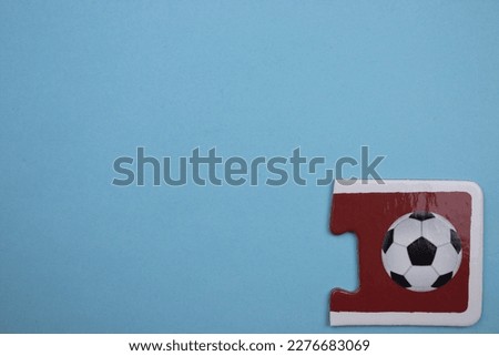 Soccer ball picture jigsaw, soccer ball picture jigsaw taken from above, placed on the right of a blue background.