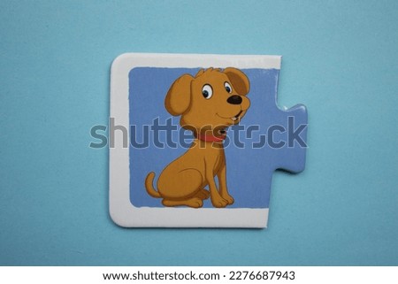 Dog picture jigsaw, dog picture jigsaw taken from above, placed on a blue background.