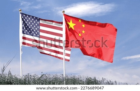 American flag with Chinese flag on cloudy sky. waving in the sky