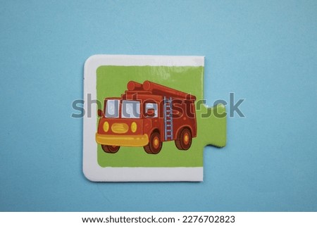 fire truck picture puzzle, fire truck picture puzzle shot from above, placed on blue background.