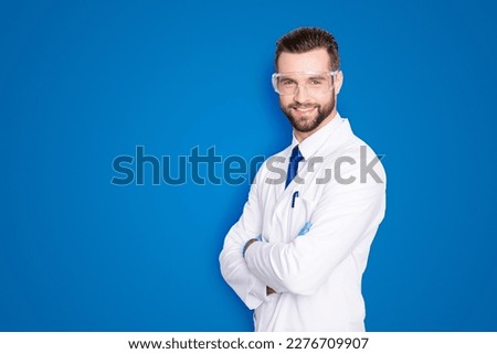Portrait with copy space, empty place of joyful half-turned scientist with stubble in white outfit with tie having his arms crossed looking at camera isolated on grey background Royalty-Free Stock Photo #2276709907