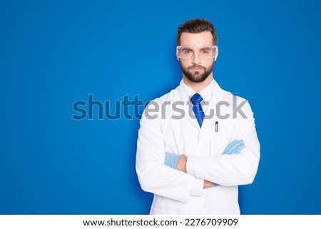 Portrait with copyspace, empty place of stylish handsome scientist with stubble in white outfit with tie having his arms crossed looking at camera isolated on grey background Royalty-Free Stock Photo #2276709909