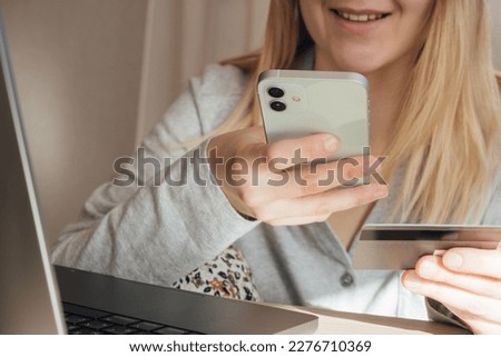 Woman hands holding plastic credit card and using laptop. Online shopping or payment concept. Toned picture. High quality photo with girl smile