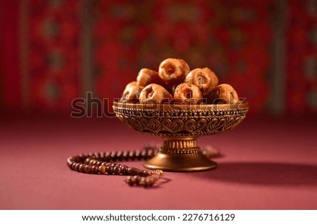 Beautiful photo for holy month of Ramadan. Arabian dates in a decorative bowl with Islamic prayer beads. Stock photo. Royalty-Free Stock Photo #2276716129