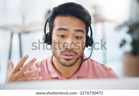 Asian man, call center and consulting with headphones on computer for customer service, help or support at office. Male consultant agent talking with headset on PC for telemarketing or online advice Royalty-Free Stock Photo #2276730471