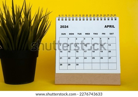 April 2024 month calendar with table plant on yellow cover background. Monthly calendar concept.