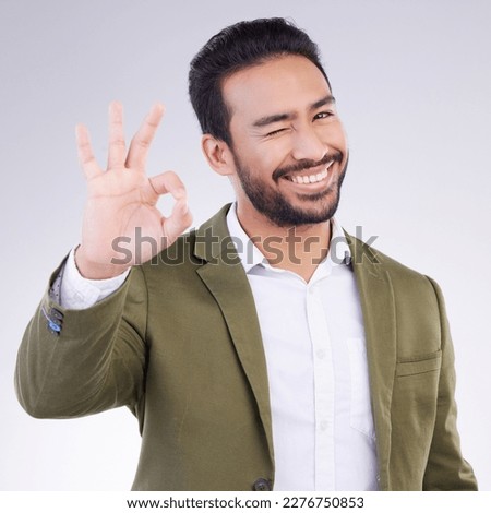 OK hand, portrait and business man isolated on a white background career, job success and agreement with wink. Like, yes and okay sign or emoji of asian person, entrepreneur or worker face in studio