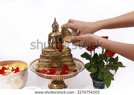 Sprinkle water onto a Buddha image, Asia culture to respect Buddha , Sonkran festival ,Buddhist Holy Day or Buddhist Sabbath Day
