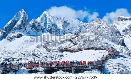 Yulong Snow Mountain is known as "Oulu", which means silver rock. It is wrapped in silver and has 13 continuous snow peaks, just like a "giant dragon" soaring and dancing, so it is called "Jade Dragon Royalty-Free Stock Photo #2276779539