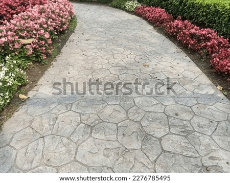 Walkway made of imprinted concrete in the park.The pattern of making a walkway in landscape. Royalty-Free Stock Photo #2276785495