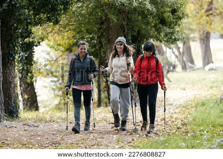 Shot of beautiful family hikers with backpack walking while looking the landscape in the mountain