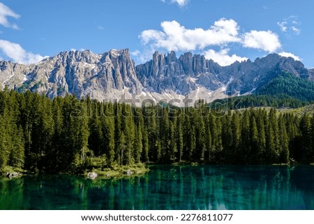 bleu lake in the dolomites Italy, Carezza lake Lago di Carezza, Karersee with Mount Latemar, Bolzano South Tyrol, Italy. The landscape of Lake Carezza or Karersee and the Dolomites in the background Royalty-Free Stock Photo #2276811077