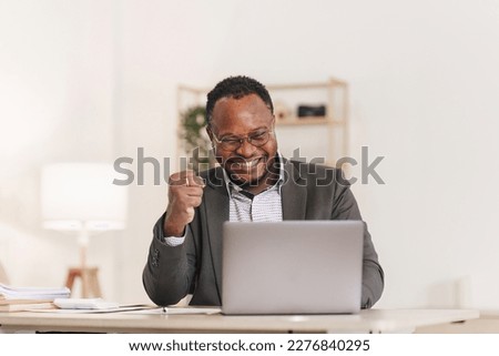 Smiling American African makes financial report and studies annual figures, analyzes profits. Accountant checks status of financial Royalty-Free Stock Photo #2276840295