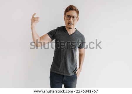 Angry and mad asian gangster with color hair and eyeglasses in black t-shirt. Royalty-Free Stock Photo #2276841767