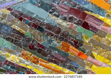 Mosaic panel from pieces of ceramic tiles, marble and granite. Abstract mosaic colored ceramic stones.
