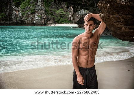 Handsome young man standing on a beach in Phuket Island, Thailand Royalty-Free Stock Photo #2276882403