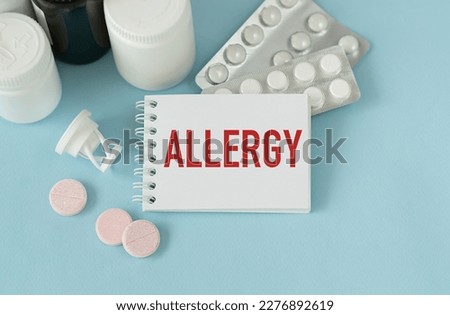 Allergy Text in Paper with Pills and Tablets on Blue Background