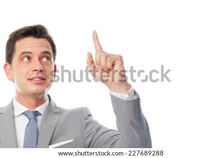 Young business man over white background. Pointing with his finger up