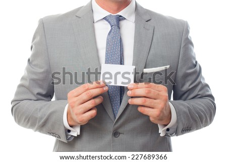 Young business man over white background. Showing a business card