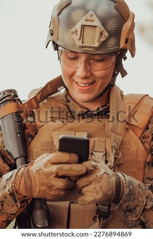 Soldier using smartphone to contact family or girlfriend communication and nostalgia concept