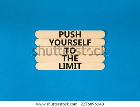 Push the limit symbol. Concept words Push yourself to the limit on wooden stick. Beautiful blue table blue background. Business push the limit concept. Copy space.