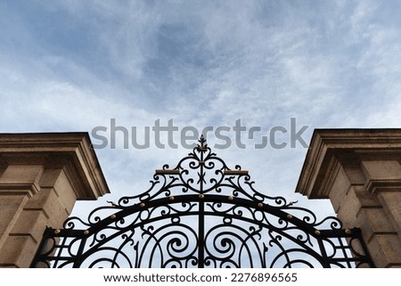 Stone pillars and wrought iron gate Royalty-Free Stock Photo #2276896565