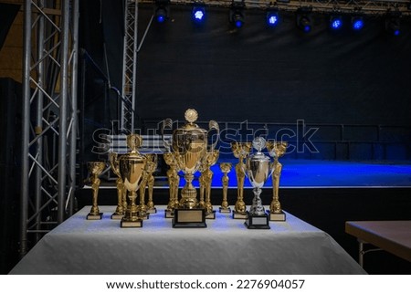 various cups are placed on a table next to the stage Royalty-Free Stock Photo #2276904057