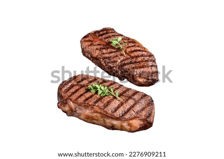 Grilled Top Blade or flat iron roast beef meat steaks on a skillet. Isolated on white background Royalty-Free Stock Photo #2276909211