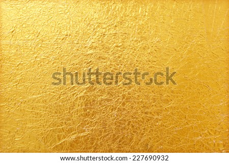 Shiny yellow leaf gold foil texture background Royalty-Free Stock Photo #227690932