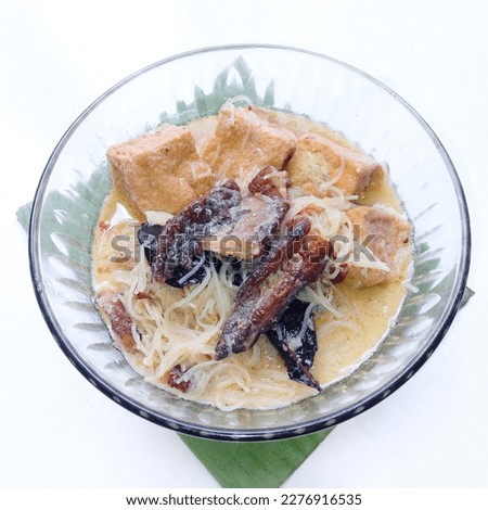 smoked stingray cooked with coconut milk and traditional spices served in a bowl on a white background. coconut milk dishes. coconut milk food. spicy and savory dishes. Tofu and vermicelli cooked Royalty-Free Stock Photo #2276916535