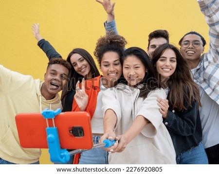 Group of diverse millennial youth taking a selfie having fun. Community and friendship concept
