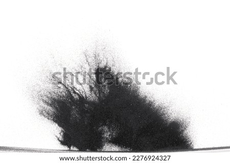 Small size black Sand flying explosion, carbon dust sands grain explode. Abstract cloud fly. Black colored sand splash throwing in Air. White background Isolated high speed shutter, throwing freeze Royalty-Free Stock Photo #2276924327