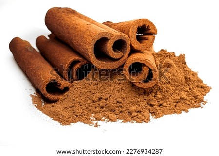Cinnamon sticks and powder close-up view, macro photography, isolated on white background high quality details