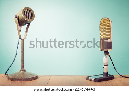 Old big retro studio microphones front mint green wall background
