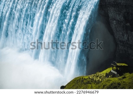 close up photo of Niagara Falls with a place for caption, Niagara Falls in the summer season is full of water