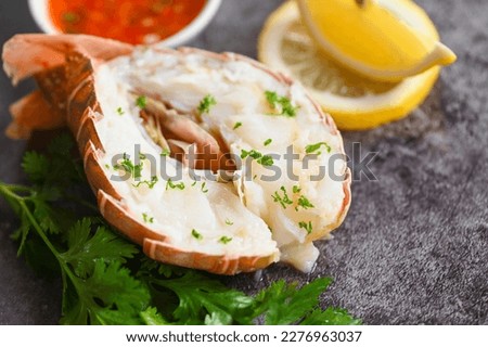 spiny lobster food on plate, fresh lobster or rock lobster seafood with herb and spices lemon coriander parsley lettuce salad, lobster for cooking food and seafood sauce  Royalty-Free Stock Photo #2276963037