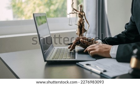 Using laptop pc, Lawyers and legal requirements and bribery in adjudicating and adjudicating litigation cases. Royalty-Free Stock Photo #2276983093