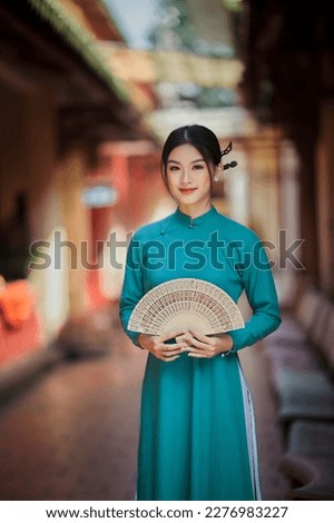 Ho Chi Minh city, Viet Nam: Vietnamese girl going to pagoda in ao dai Royalty-Free Stock Photo #2276983227