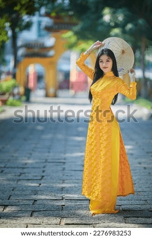 Ho Chi Minh city, Viet Nam: Vietnamese girl going to pagoda in ao dai Royalty-Free Stock Photo #2276983253