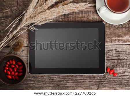 The tablet on a wooden background