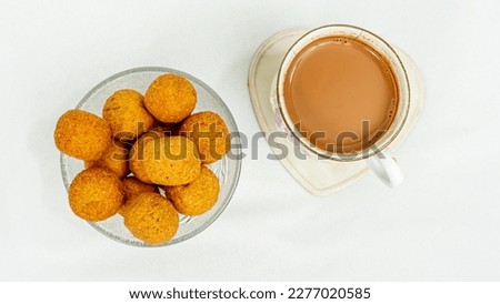 Top View Of Famous Indian Gujarati Snack Kachori Is Small And Round Shape Ball Served In Glass Bowl With Tea Cup