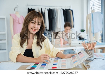Professional female fashion designers are thinking about designing fashion clothes to tailor for customers.