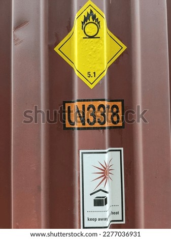 Shipping container containing dangerous goods label yellow class 5.1 , UN No 3378 and keep away from heat