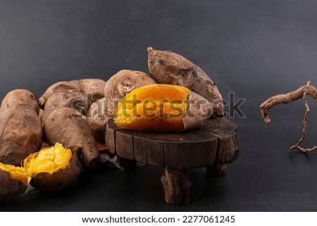 roasted sweet potatoes on a black background