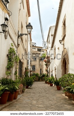 The narrow alleys of Tossa de Mar, Spain, lead to hidden courtyards and picturesque squares.