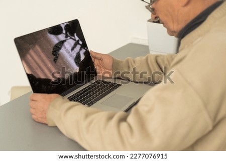 Busy smart mature professional man using laptop sitting. Middle aged older adult businessman, senior entrepreneur of mid age remote working or learning online typing on computer.
