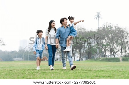 Asian family photo walking together in the park Royalty-Free Stock Photo #2277082601